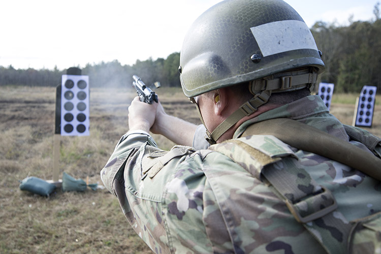 A soldier assigned to the U. S. Army John F. Kennedy Special Warfare Center and School who is in the Special Forces Weapons Sergeant Course fires a pistol during small arms training at Fort Bragg, North Carolina November 4, 2019. The soldiers were trained to employ, maintain and engage targets with select U.S. and foreign pistols, rifles, shotguns, submachine and machine guns, grenade launchers and mortars and in the utilization of observed fire procedures. (U.S. Army photo illustration by K. Kassens)