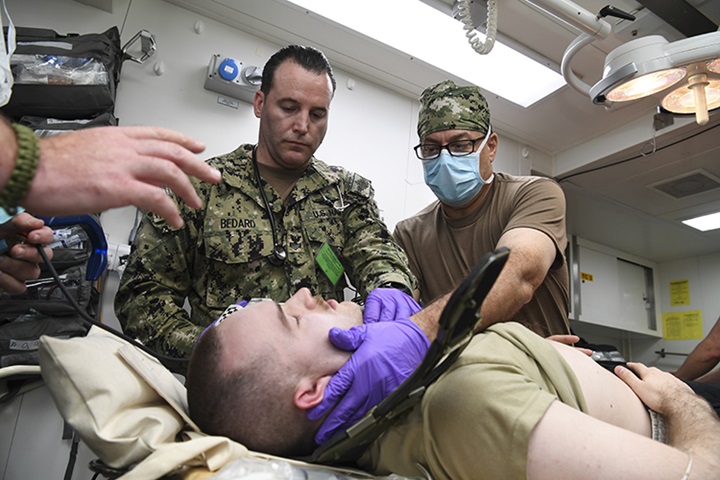 Image of Medical Service members prepare resuscitation on patient.