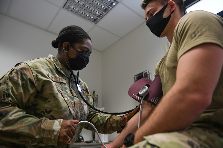 Image of Tech. Sgt. Kimberly Weaver, 606th Air Control Squadron noncommissioned officer in charge of medical readiness, measures an Airman’s blood pressure at Aviano Air Base, Italy, May 10, 2021. Click to open a larger version of the image.