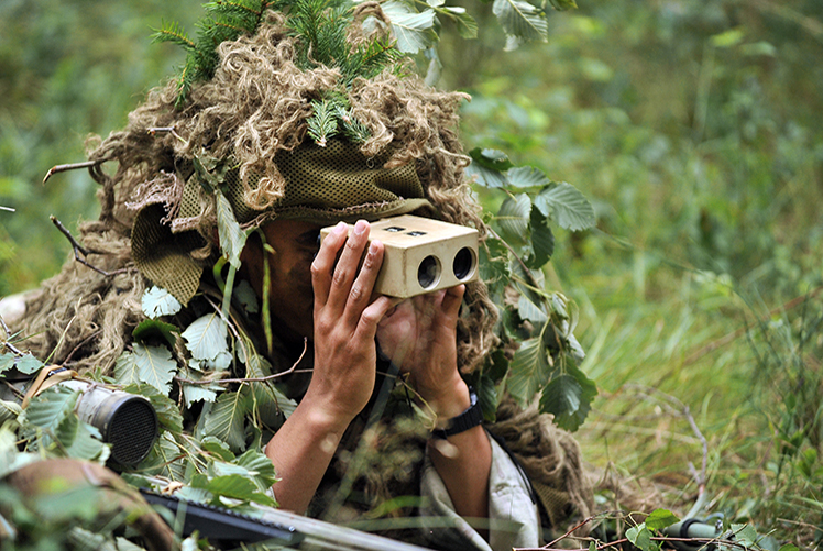 A paratrooper with 1st Squadron, 91st Cavalry Regiment, 173rd Airborne Brigade lies concealed in a forest and observes his target during a combined sniper exercise with the British Army's 1st Battalion, Royal Irish Regiment as part of Exercise Wessex Storm at the 7th Army Joint Multinational Training Command's Grafenwoehr Training Area, Germany, July 30, 2015. Wessex Storm is an annual maneuver exercise for British forces, integrating NATO allies and partners. (U.S. Army photo by Visual Information Specialist Gertrud Zach/released)