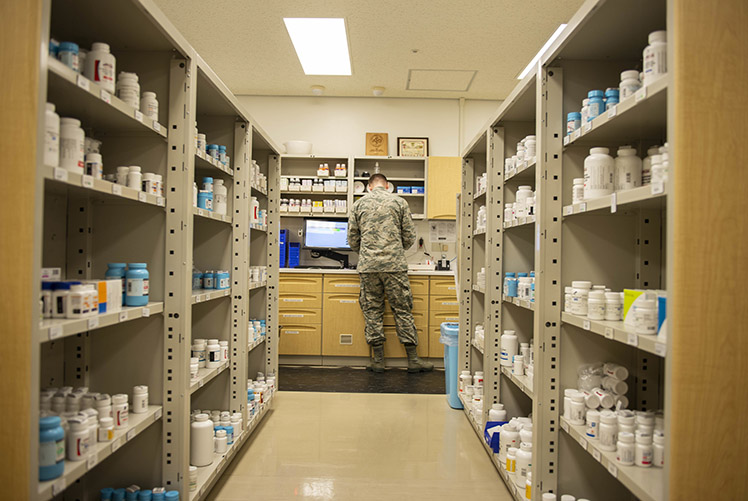 U.S. Air Force Tech Sgt. Ryan Marr, 18th Medical Group pharmacy craftsman, processes prescriptions, June 8, 2018, at Kadena Air Base, Japan. The pharmacy processes and fills prescriptions for hundreds of different medical needs. (U.S. Air Force photo by Staff Sergeant Jessica H. Smith) Merriam/Released)