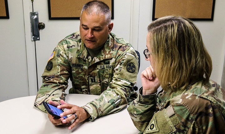 Ohio Army National Guard Capt. Michael Barnes talks to a Soldier about the Ohio Vet 2 Vet Network, a website and mobile app with information and resources for military veterans and their families to combat the risk factors of suicide among veterans. (U.S. Army photo by Staff Sgt. Michael Carden)