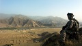 A soldier looks out over a valley in the Kunar Province of Afghanistan while on patrol. 