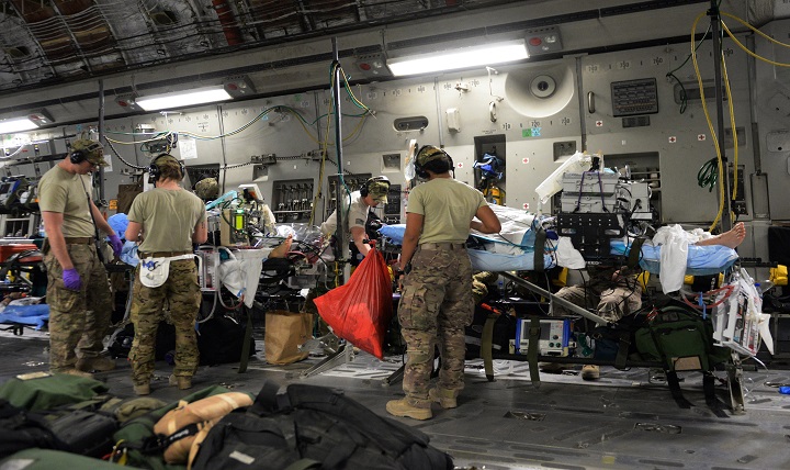 U.S. Airmen assigned to the 455th Expeditionary Aeromedical Evacuation Squadron provide in flight medical care to injured service members on a C-17 Globemaster III aircraft that departed Bagram Air Field, Afghanistan, heading for medical care in Germany. 