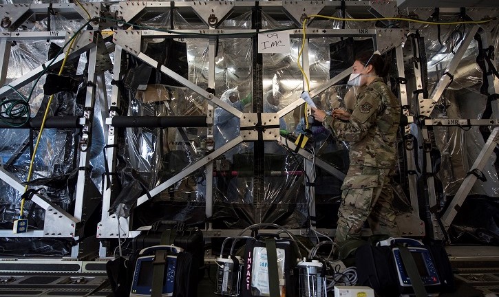 Military Captain and team cleaning large, plastic enclosed space