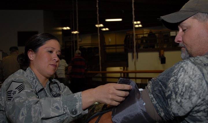 Master Sgt. Kim Groat, 168th Medical Group aerospace medical technician, performs a blood pressure test for a veteran during the Veteran Stand Down at Pioneer Park Civic Center in Fairbanks, Alaska. (Air Force photo by Senior Airman Francine St. Laurent)