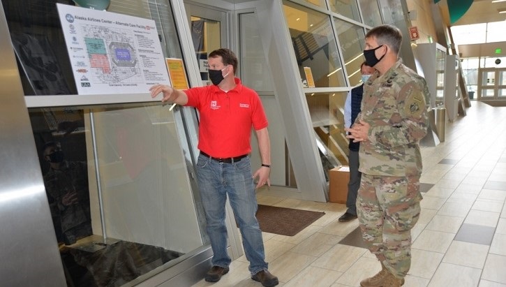 Image of a contractor and a soldier looking at a blueprint