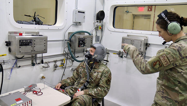 Military personnel running an oxygen system test in an Altitude Chamber