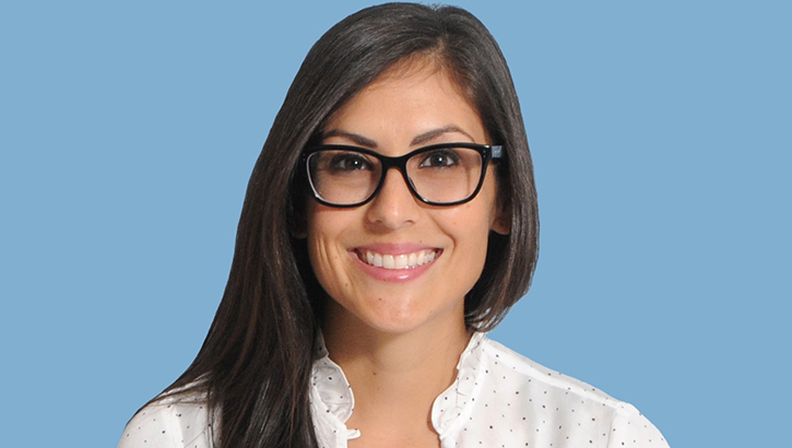 Image of Photo of woman wearing glasses in a white blouse.