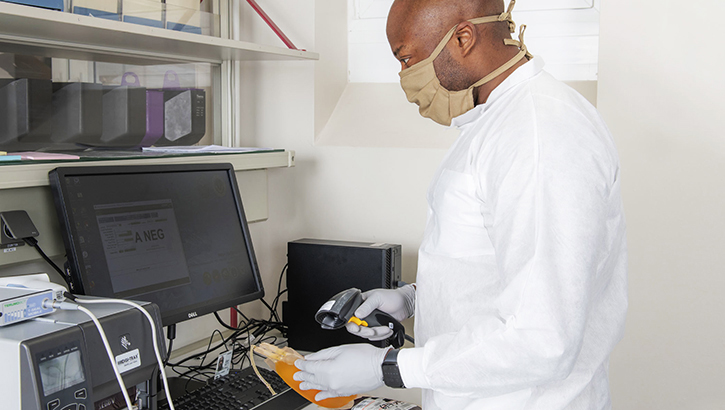Image of a researcher scanning a unit of plasma in a lab. Click to open a larger version of the image. Click to open a larger version of the image.