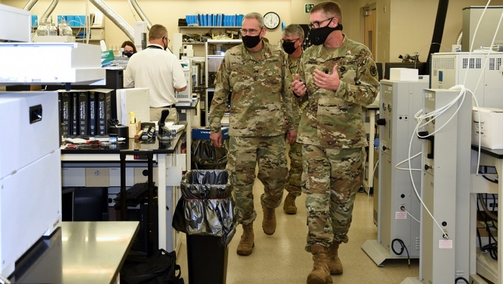 Military personnel explaining forensic equipment
