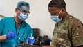 Military medical personnel perform dental procedure