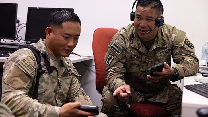 From the left, U.S. Army Capt. Vy Nguyen, legal officer, and U.S. Army Maj. Michael Lozano, health information system officer, both 18th Medical Command, discuss their respective administrative processes during Exercise Talisman Sabre 2023, on July 15, 2023.  (Photo: U.S. Army Sgt. 1st Class Timothy Hughes) 