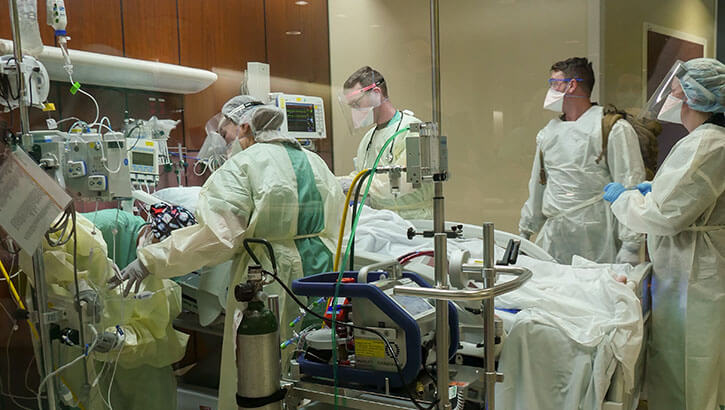 Image of Trauma personnel receive an extracorporeal membrane oxygenation or ECMO patient into the Emergency Department at Brooke Army Medical Center, Joint Base San Antonio-Fort Sam Houston, Texas, Jan. 24, 2022. MHS GENESIS new functionalities support BAMC’s Level I Trauma Center. (Photo: Corey Toye, Brooke Army Medical Center). Click to open a larger version of the image.