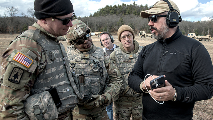 Military personnel and civilian researchers at a training at Fort McCoy