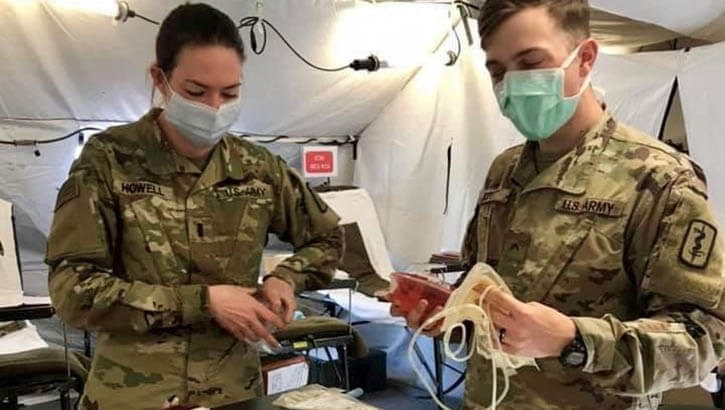 Military personnel handling blood samples