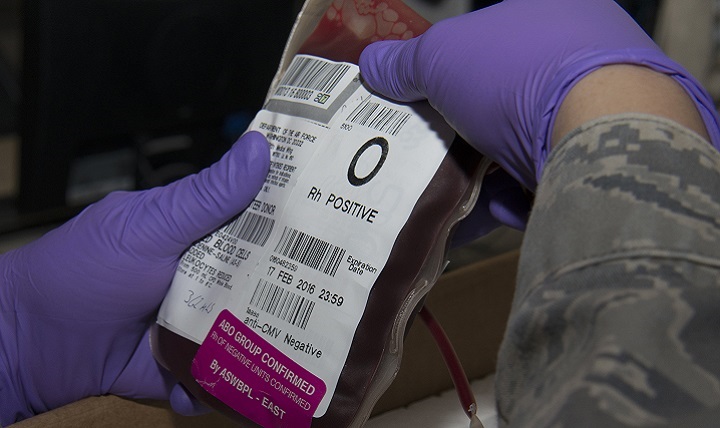Air Force Master Sgt. Stephanie Washington, 379th Expeditionary Medical Support Squadron Diagnostics and Therapeutics flight chief, inspects a red blood cell unit before placing the unit into a box to be shipped at the Blood Transshipment Center at Al Udeid Air Base, Qatar.