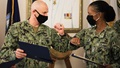 Miliary health personnel wearing face mask bumping elbows