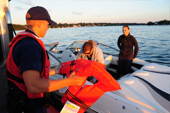 Military personnel checking on-board safety equipment