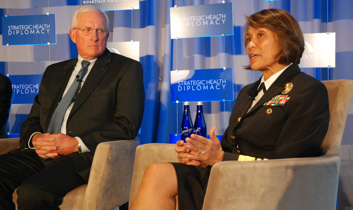 Navy Vice Adm. Raquel Bono (right), director of the Defense Health Agency, talks about a whole of government approach when engaging other countries, while Thomas Cullison, the senior adviser for the Uniformed Services University’s Center for Disaster and Humanitarian Assistance, listens. The two were part of a panel discussion at the Strategic Health Diplomacy conference in Washington, D.C., Nov. 9, 2015.