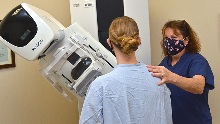Michelle Kincaid, a mammography technologist at Naval Hospital Jacksonville, assists a patient during a mammogram. Kincaid, a native of Allentown, Pennsylvania, says, “A mammogram exam is quick, efficient, and lifesaving. I enjoy explaining the importance of mammograms. It's a good feeling, knowing that I might have helped catch something in an early stage.” Mammograms are the best way to find breast cancer early, when it’s easier to treat and before it’s big enough to feel. Starting at age 40, talk with your primary care manager about when to start and how often to get a mammogram. You have the choice to get an annual mammogram at age 40 and up. (U.S. Navy photo by Jacob Sippel, Naval Hospital Jacksonville/Released).