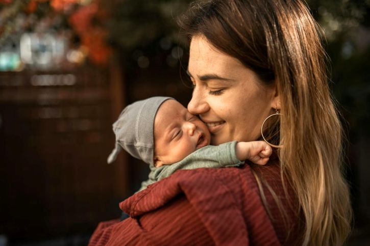 A mother carrying her child