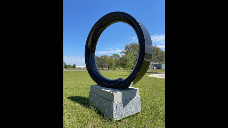 Image of a statue of a broken circle. Click to open a larger version of the image.
