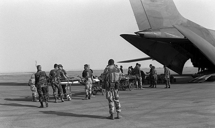 Medical personnel use litters to transport wounded to an Air Force C-141B Starlifter aircraft.  The patients were being medically evacuated from Al-Jubayl Air Base, Saudi Arabia to Germany during Operation Desert Storm. 