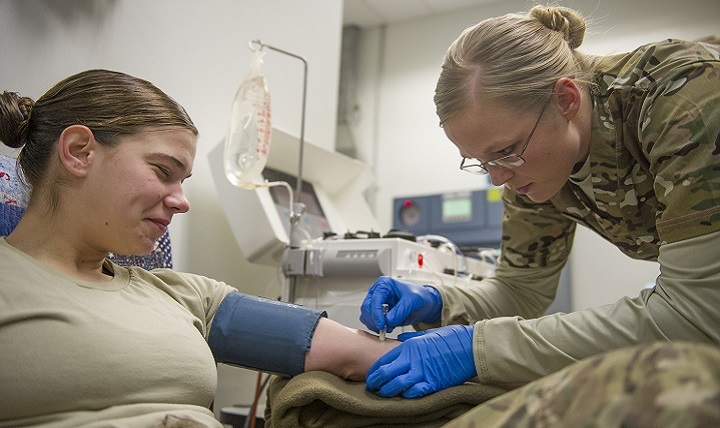 Army Spc. Lauren O'Neal, 153rd Blood Support Detachment medical laboratory technician, prepares Spc. Samantha Criscio, Guard Force, to give platelets at Craig Joint Theater Hospital on Bagram Airfield, Afghanistan, Dec. 31, 2015. 