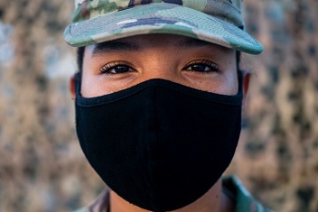 Military personnel wearing a mask