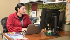 Capt. Aisha Perez, director of prenatal and gestational nutrition at the Women’s Health Clinic, reviews patient information
