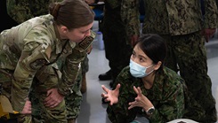 U.S. Air Force Capt. Hooten, left, a clinical nurse assigned to the 18th Healthcare Operations Squadron, answers questions from a Japan Air Self-Defense Force captain during a neonatal care briefing