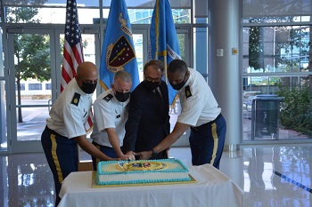 Military personnel cutting a celebration cake