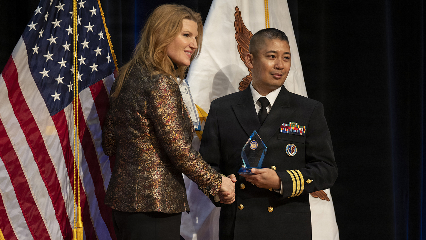 Image of Cmdr. Raben B. Talvo accepting an award.