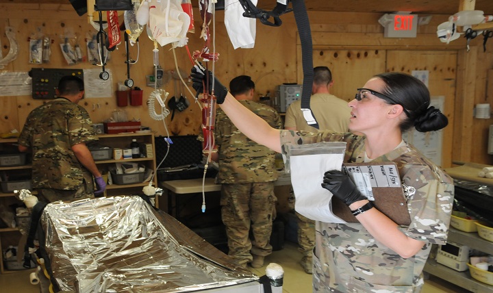 Army Specialist Diana Fontenelle preps blood for an incoming trauma patient.
