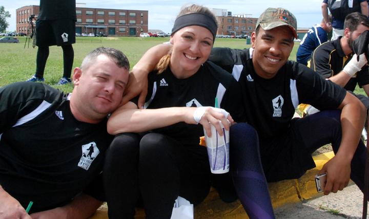 Relaxing outside of Marine Corps Base Quantico’s Barber Gym at the 2015 Warrior Games, Team Army’s Sgt. Patrick Timmins, retired Staff Sgt. Randi Gavell and Sgt. Blake Johnson await a sitting volleyball seeded match against the British Armed Forces on June 25.