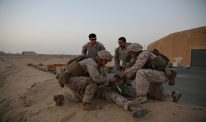 Marine Lance Cpl. Fred Hass (left) and Lance Cpl. Clinton Turman (right), both with the Ground Combat Element, Special Purpose Marine Air-Ground Task Force-Crisis Response-Central Command, treat a patient during the final test of the Combat Life Savercourse.