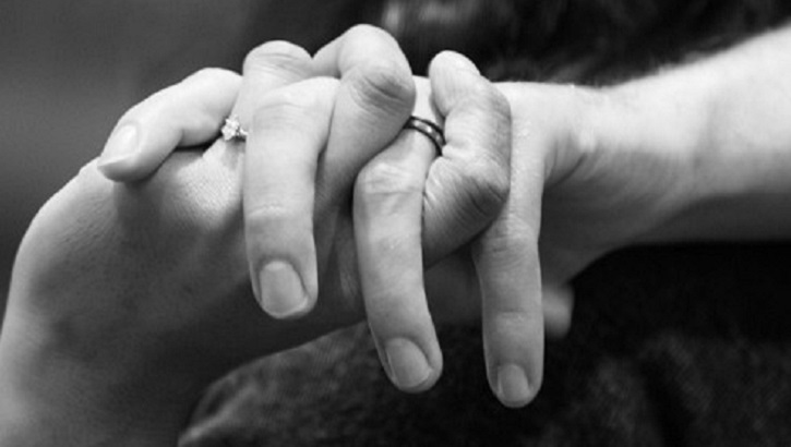 Image of Black and white photo of a couple holding hands. Click to open a larger version of the image.