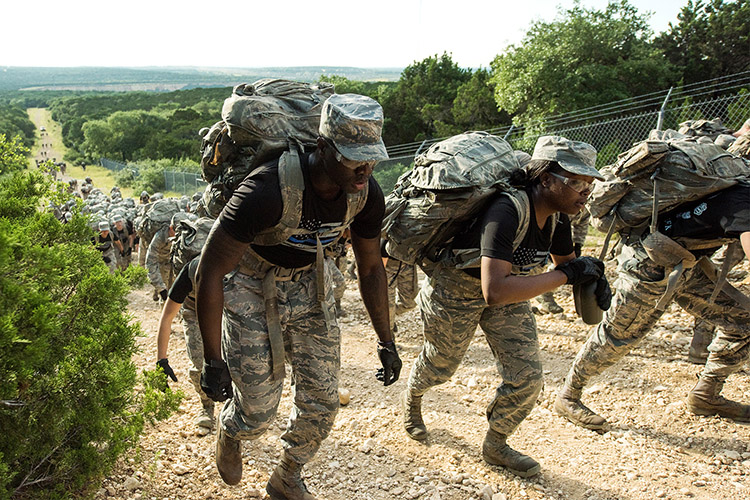Image of Air Force security forces trainees climb a hill during a 3-mile ruck march to commemorate National Police Week at Joint Base San Antonio, May 13, 2019. Photo By: Sarayuth Pinthong, Air Force.