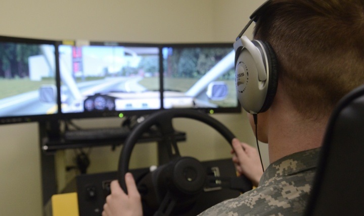 A soldier at Joint Base Elmendorf-Richardson’s traumatic brain injury clinic in Alaska takes a cognitive hand-eye coordination test on a driving stimulator. 