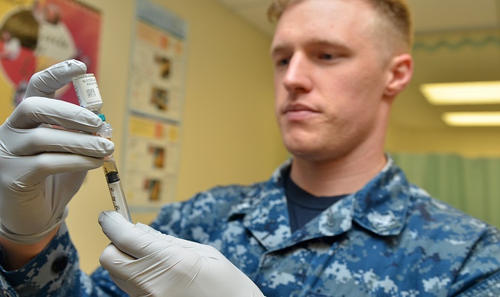 Navy Petty Officer 3rd Class Brett Friebel prepares a flu shot for a patient at Naval Branch Health Clinic Mayport’s immunizations clinic. (U.S. Navy photo by Jacob Sippel)