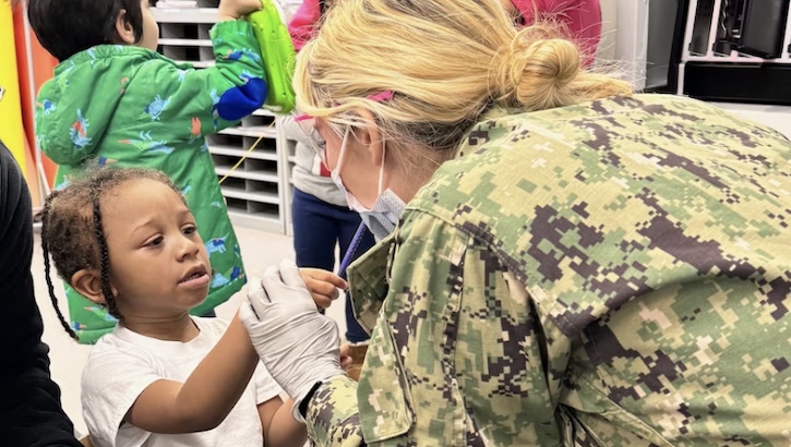 U.S. Navy Lt. Kathleen Parr, general practice resident at Walter Reed National Military Medical Center Hospital Dentistry, let’s a child demonstrate a dental exam on her before switching roles at Child Development Center (CDC) on Naval Support Activity Bethesda.