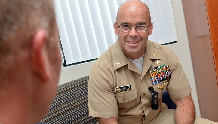 Image of naval captain talking to another military person. Click to open a larger version of the image.