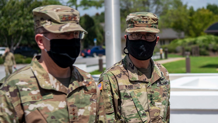 Image of Two soldiers in masks, talking. Click to open a larger version of the image.