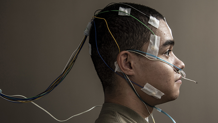 Airman with elecronic trackers on his head seen in profile for a sleep disorder study on TSD.