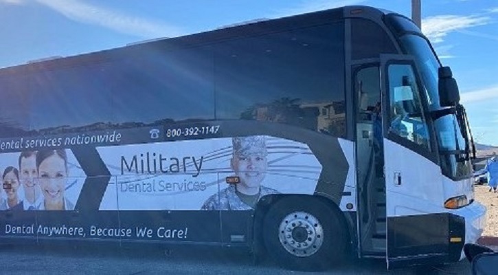 Image of a bus with the words "Military Dental Services" on the side. Click to open a larger version of the image.