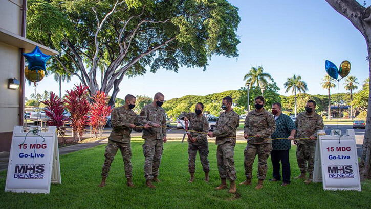 Col. Stephanie Ku, 15th Medical Group commander, cuts a cord with 15th MDG members and Military Health System Genesis project integrators during the MHS Genesis launch ceremony at Joint Base Pearl Harbor-Hickam, Hawaii, Sept. 25, 2021.