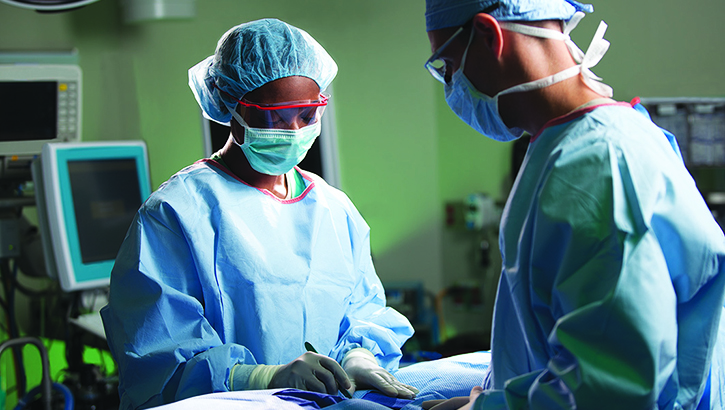 Image of Two surgeons in an operating room. Click to open a larger version of the image.