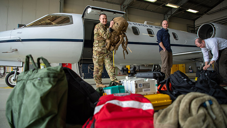 U.S. Air Force Tech. Sgt. Brendon Bowman, 86th Aeromedical Evacuation Squadron flight examiner and emergency medical paramedic, unloads medical equipment from a C-21 Learjet at Ramstein Air Base, Germany. (Photo by U.S. Air Force Airman 1st Class Jordan Lazaro) 