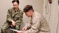 Hospital Corpsman 3rd Class Jared Angapak, left, reviews the results of an audiogram with Marine Corps Lance Cpl. Carson Groom at the Adult Medical Care Clinic